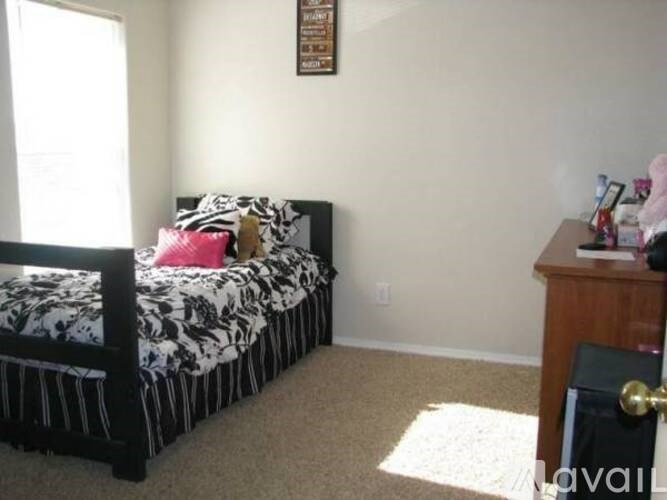A bedroom with a bed, a dresser, and a window.