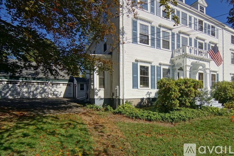 A white house with a flag on the front porch.
