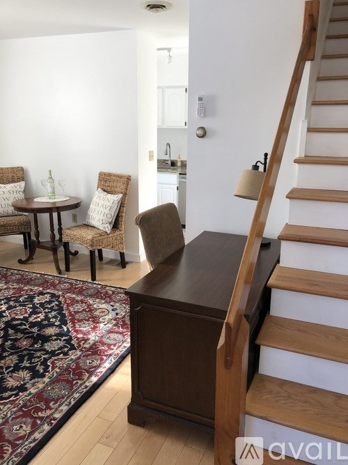 A brown wooden staircase with a white railing.