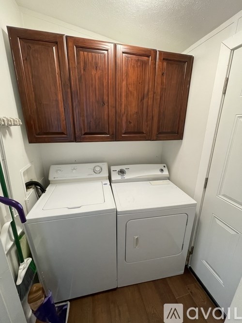 A small laundry room with a washer and dryer.