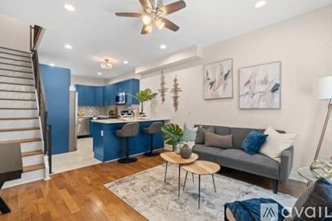 A living room with a grey couch and a wooden coffee table.