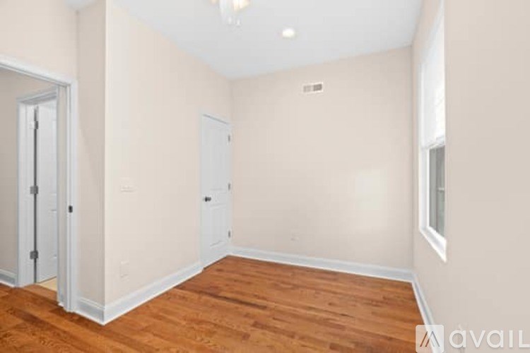 A room with wooden floors and white walls.