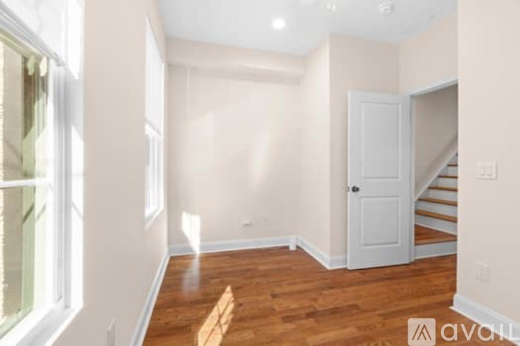 A room with wooden floors and a white door.