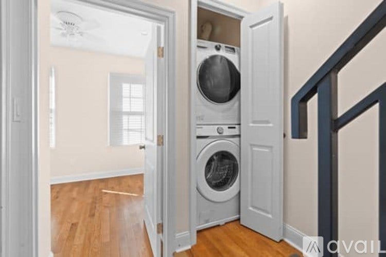 A washer and dryer are built into a wall in a room.