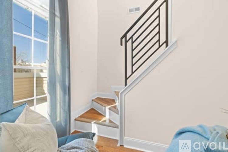 A staircase with a metal railing and wooden steps.