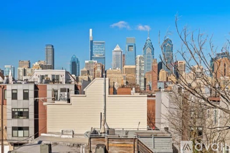 A cityscape with buildings of various heights and architectural styles under a clear sky.