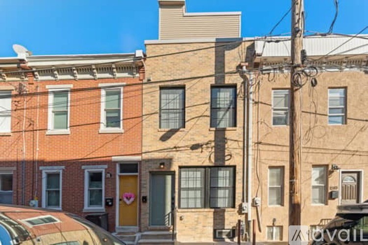 A row of houses with a yellow door in the middle.