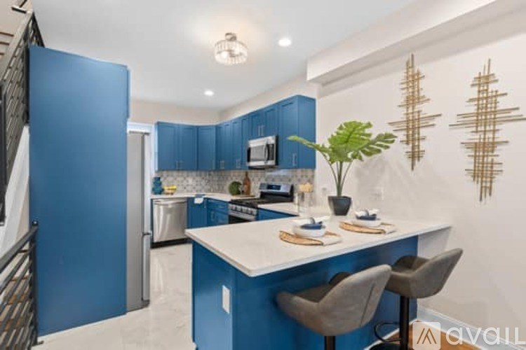 A kitchen with blue cabinets and a white island.