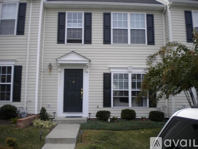 A house with a black front door and white trim.