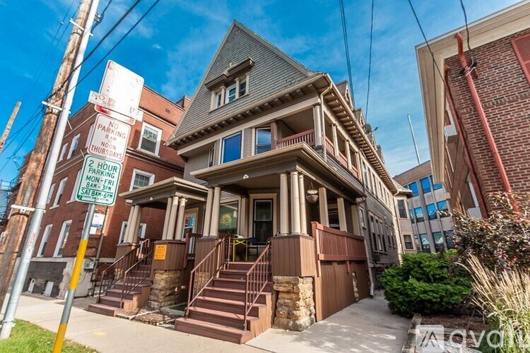 A house with a sign in front of it that says "PARKING LIMITED TO 2 HOURS BETWEEN 8AM AND 6PM EXCEPT RESIDENTS".