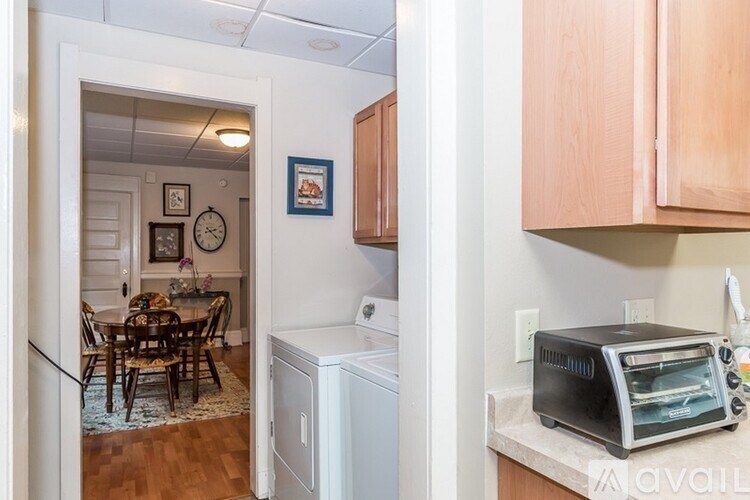 A kitchen with a toaster on the counter.