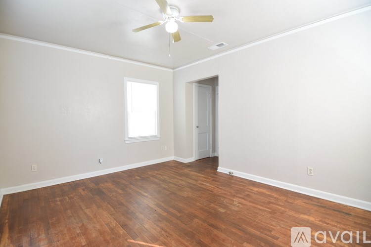 A white toilet is in a bathroom with a sink and a bathtub.