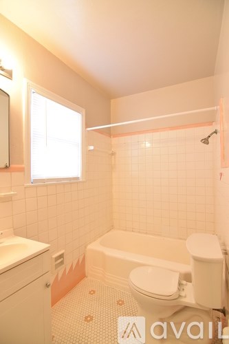 A small bathroom with a toilet, sink, and bathtub.