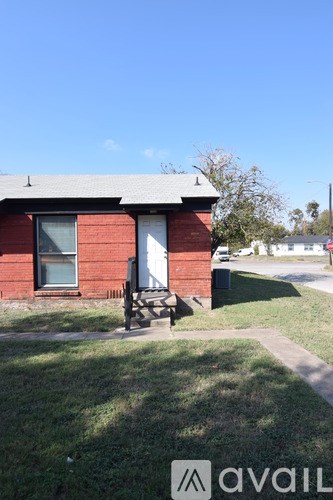 A small kitchen with a stove, sink, and cabinets.