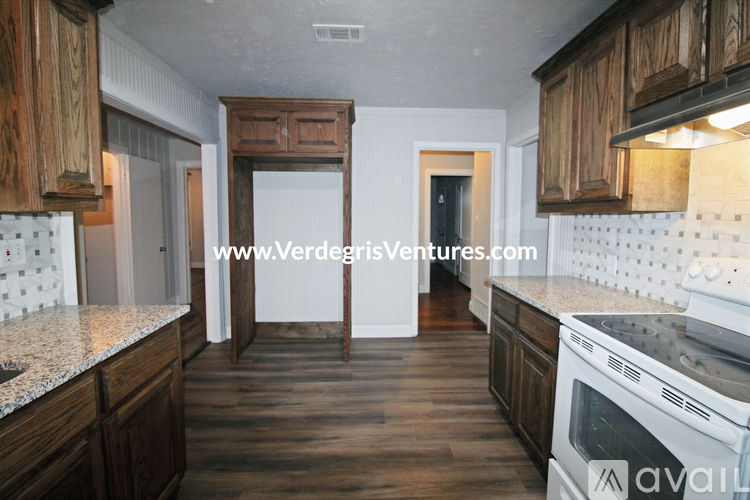 A kitchen with wooden cabinets and a white countertop.