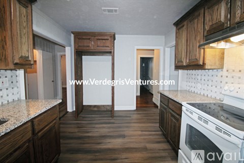 A kitchen with wooden cabinets and a white countertop.