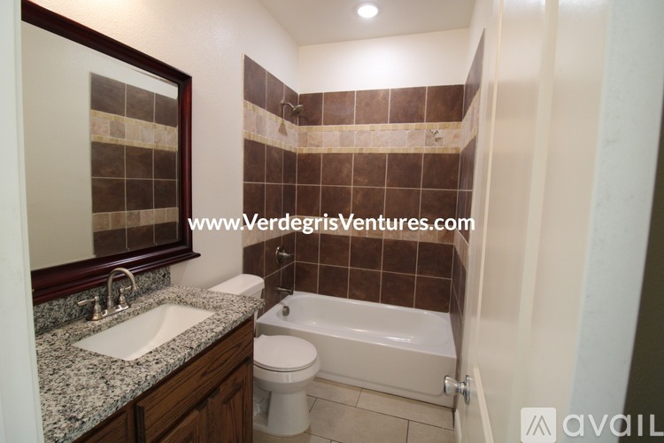 A bathroom with a sink, toilet, and bathtub.