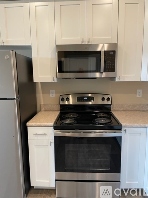 A kitchen with a stove top oven and microwave above it.
