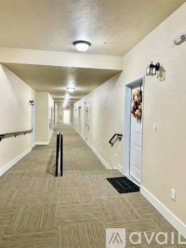 A hallway with a black suitcase on the floor.