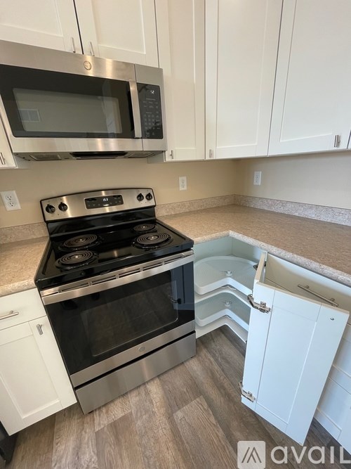 A kitchen with a stove top oven and microwave.