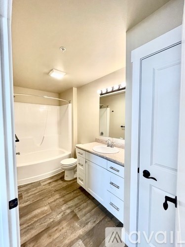 A bathroom with a white sink and a white toilet.