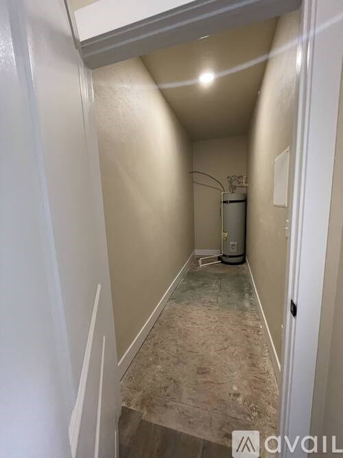 A hallway with a floor covered in tiles and a wall-mounted air conditioner unit.