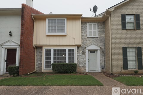 A house with a red brick chimney and a white door.