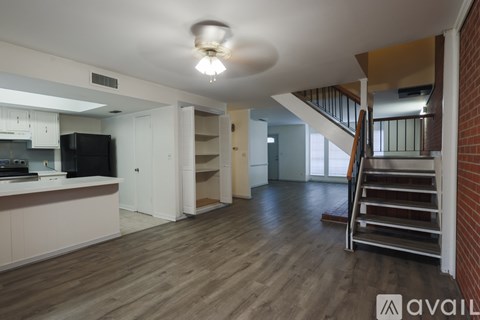 A living room with a staircase leading to the upper floor.