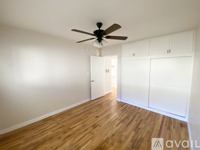A room with a ceiling fan and a window.
