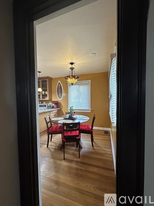 A dining room with a table set for four.