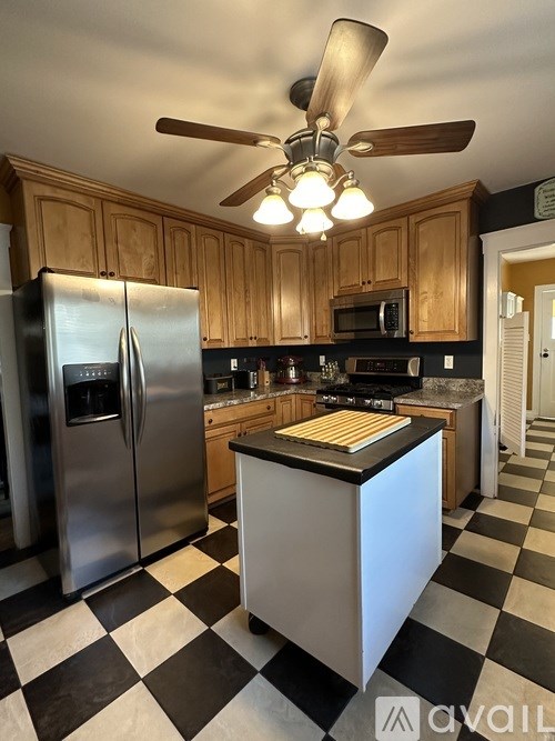 A kitchen with black and white checkered floor.