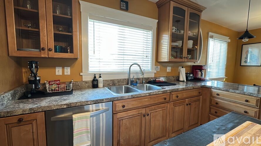 A kitchen with wooden cabinets and granite countertops.