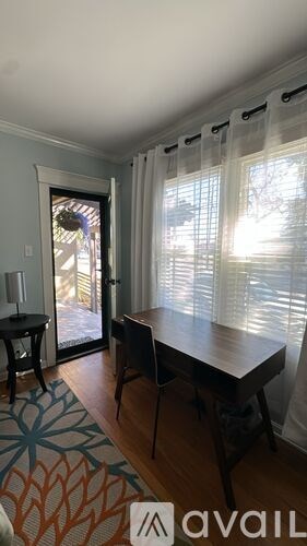 A dining room with a table and chairs.