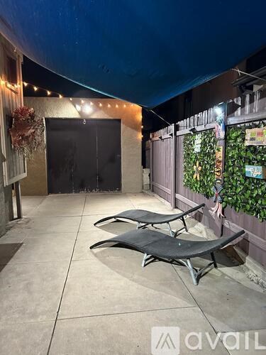 Two lounge chairs are placed on a patio.