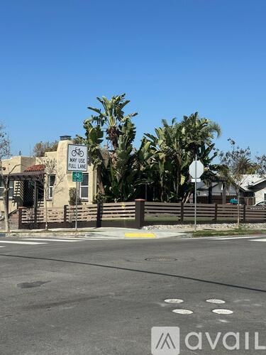 A street view with a sign that says "MAY USE FULL LANE".