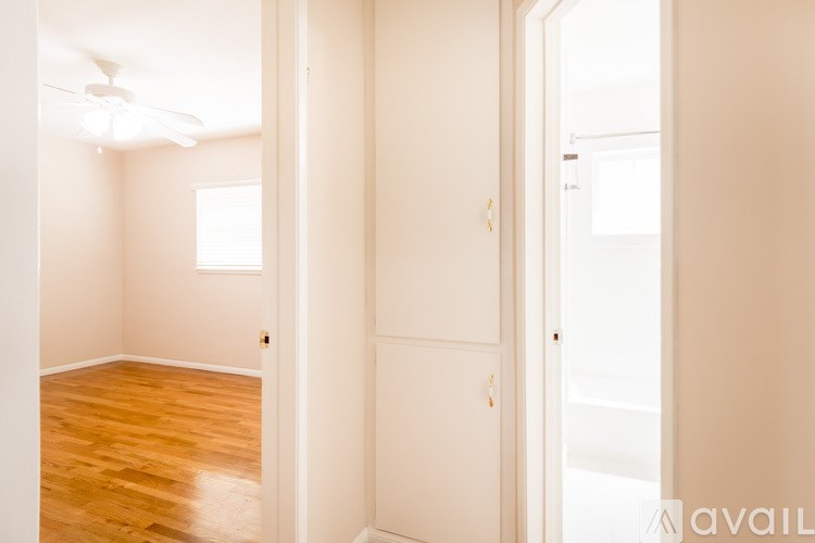 A room with a wooden floor and white walls.