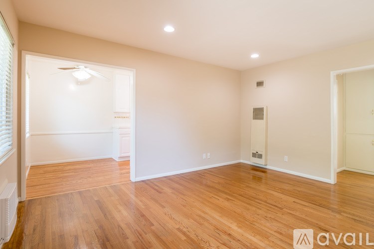 A room with wooden floors and white walls.