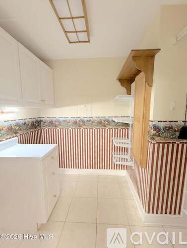 A room with wooden floors and a ceiling fan.