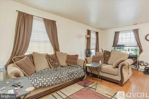 A living room with a patterned couch and a small table.