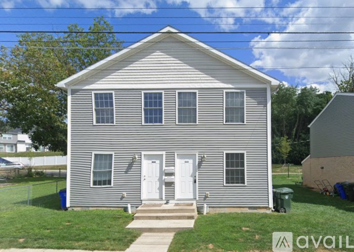 A two-story house with a grey exterior and white trim.