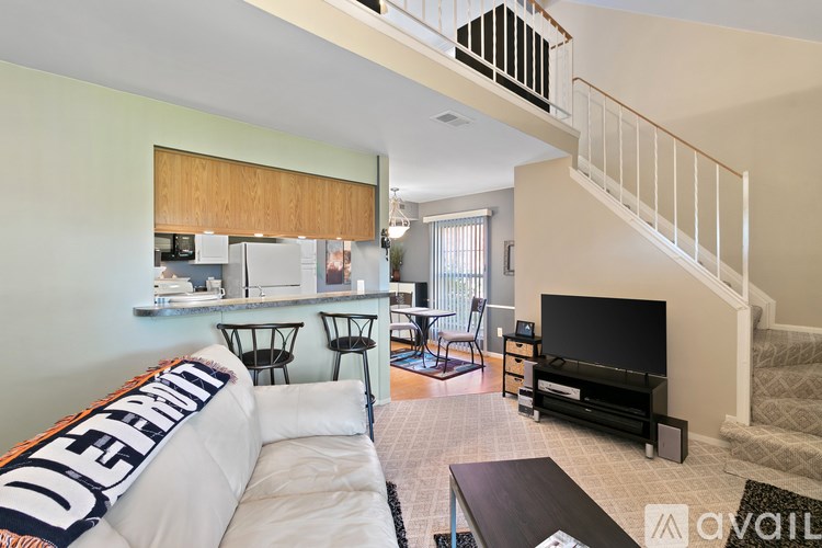 A living room with a white couch and a television.