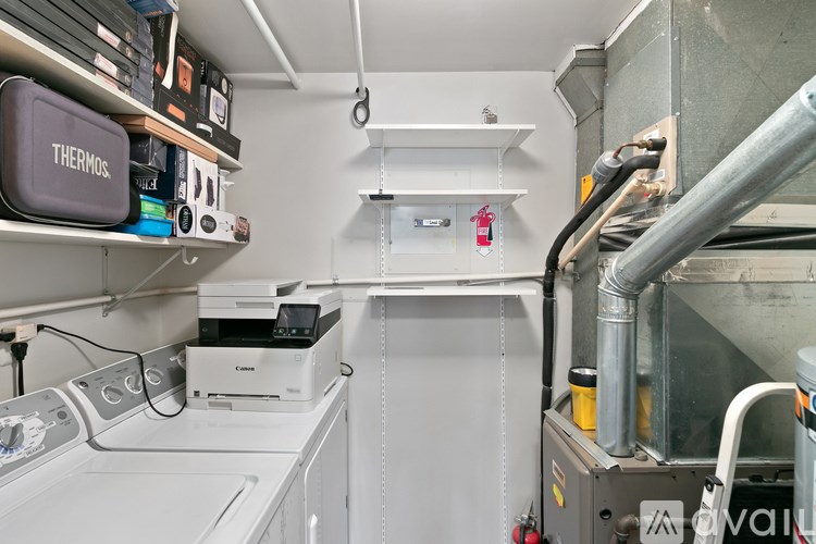 A Thermos is sitting on a shelf in a clean, white-walled industrial space.