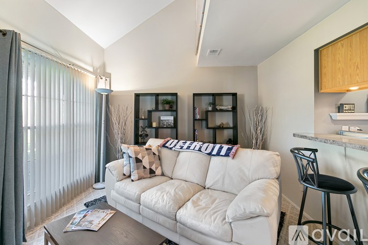 A living room with a white couch and a coffee table.