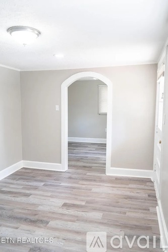 A small, empty room with a washer and dryer.
