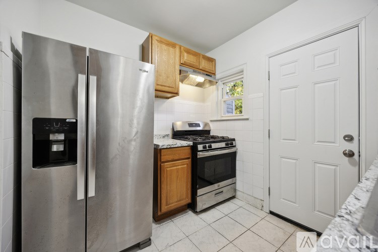 A kitchen with a stainless steel refrigerator and a stove top oven.