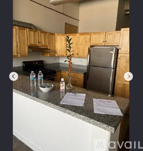 A kitchen with wooden cabinets and a granite countertop.
