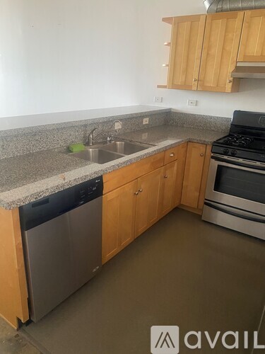 A kitchen with wooden cabinets and a granite countertop.