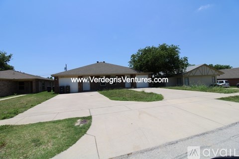 A residential area with houses and a clear sky.