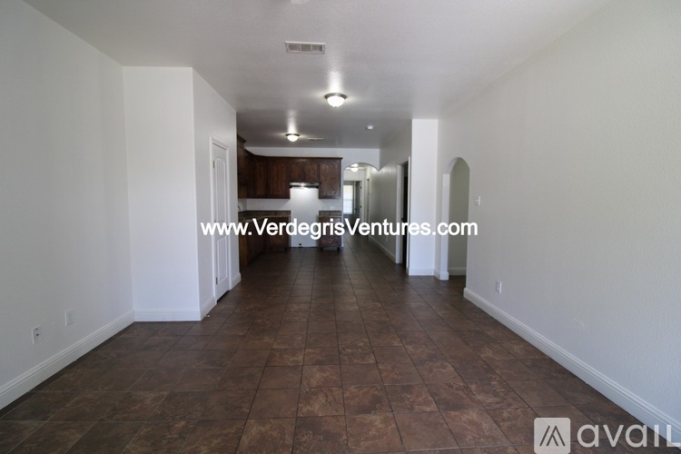 A long hallway with a tiled floor and white walls.