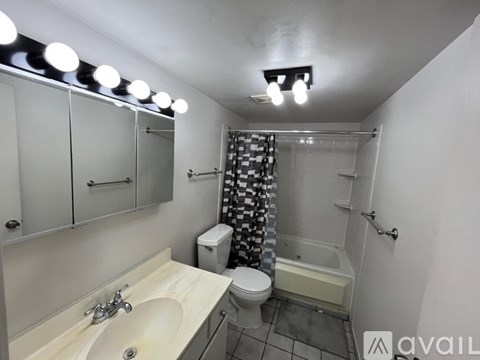 A bathroom with a sink, toilet, and shower.